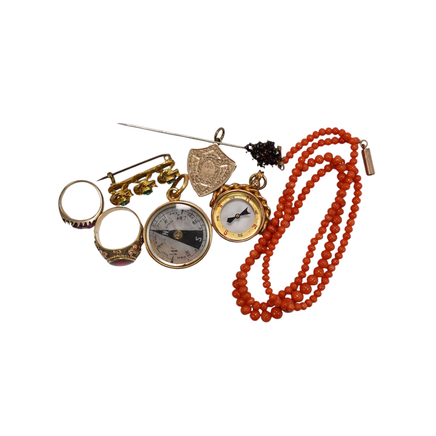 A small group of assorted jewellery including a coral necklace, 9c compass fob, five yellow metal items including a ring, locket and brooch and a stick pin. Condition - poor to fair